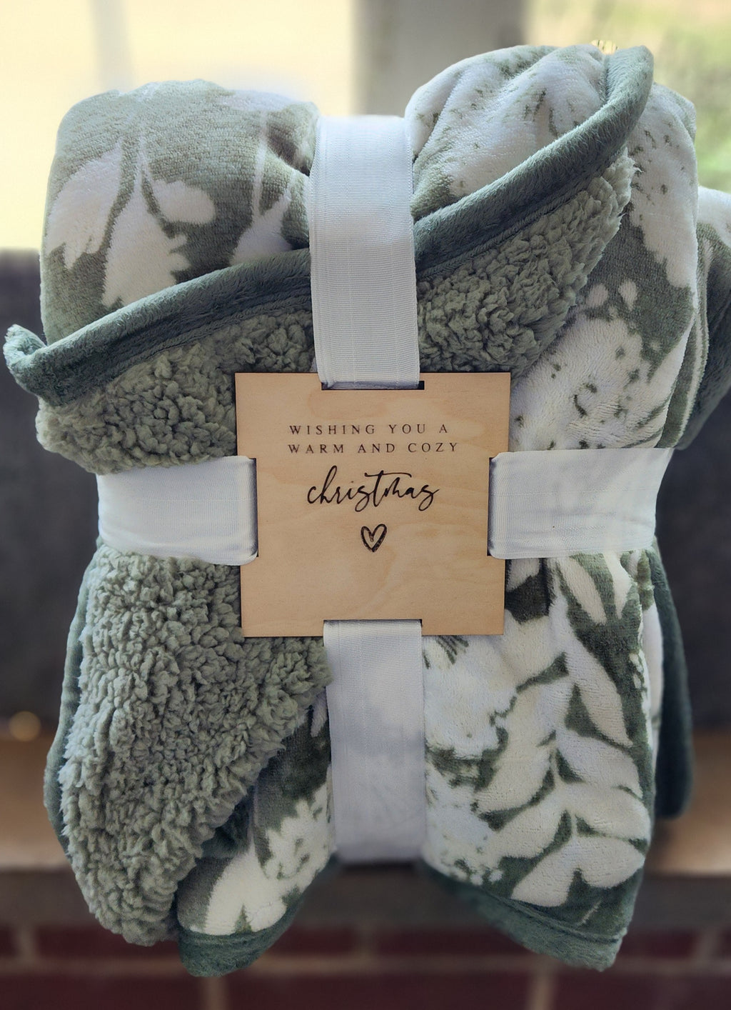 engraved wooden gift tag on blanket